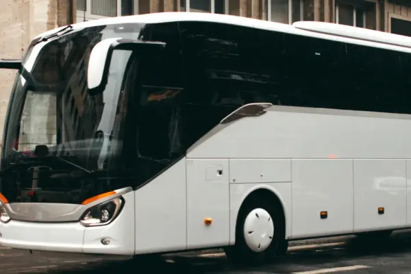 a white touring bus on the road