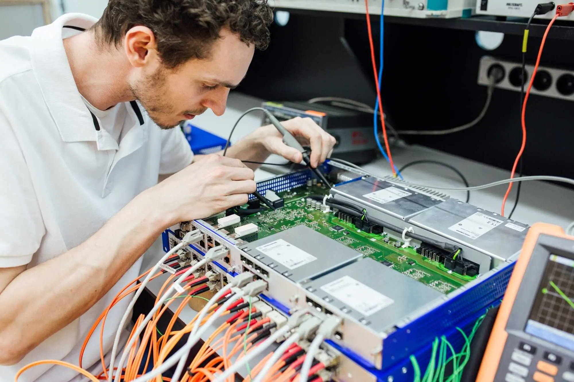 DEKRA employee testing electronic device (IEC 62368) DEKRA employee testing electronic device (IEC 62368)