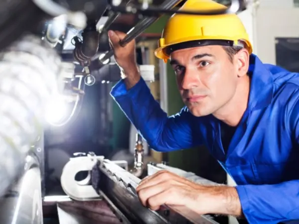 industrial worker inspects a machine industrial worker inspects a machine