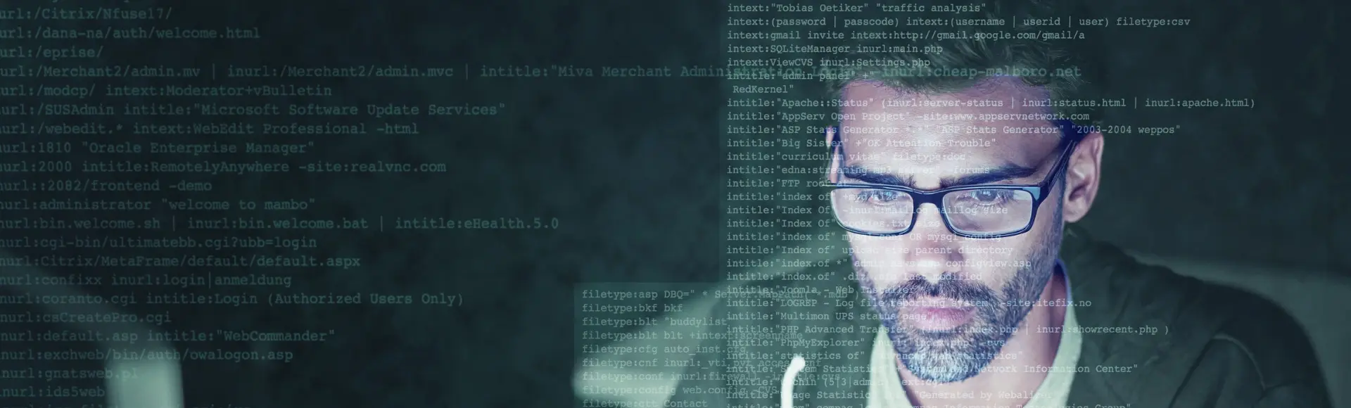 man behind computer with coding on laptop