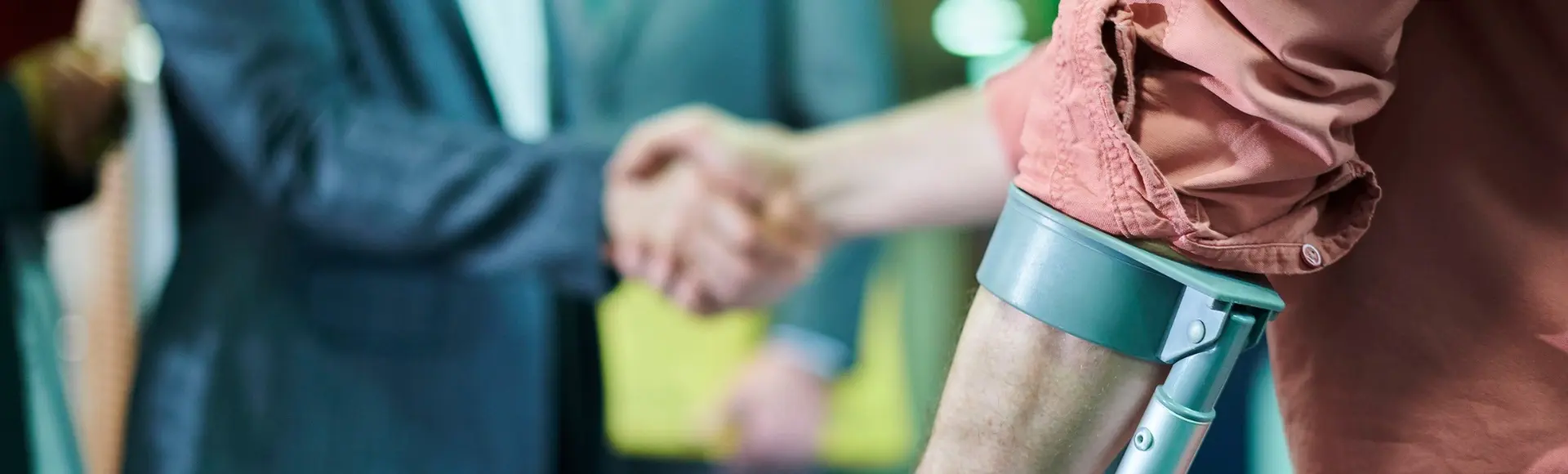 Man with injury gives hand to lawyer