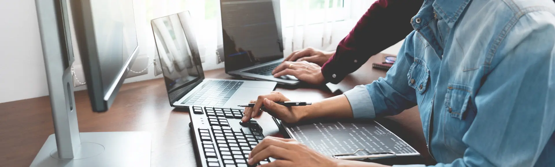 Two colleagues on laptops Two colleagues on laptops
