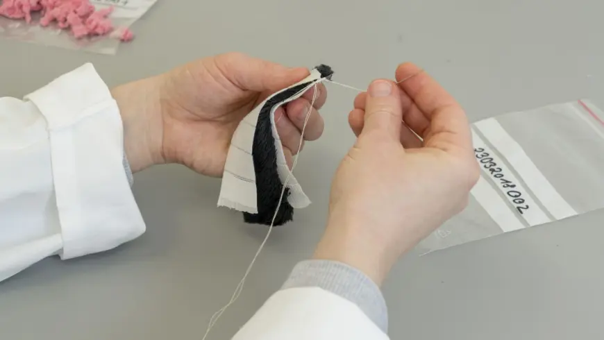 The test strips are sewn together with white fabric ...