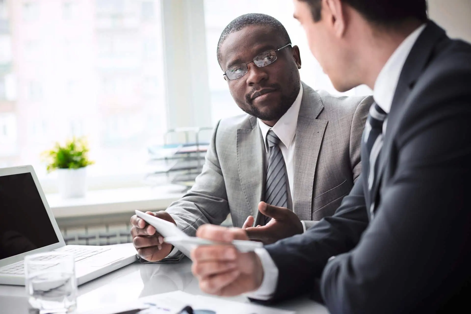 People talking in front of a computer People talking in front of a computer