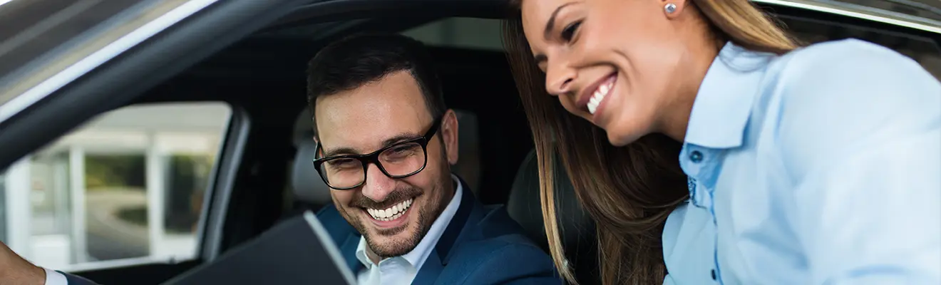 Automotive Audit Consultation Business professionals reviewing information on a tablet inside a vehicle.