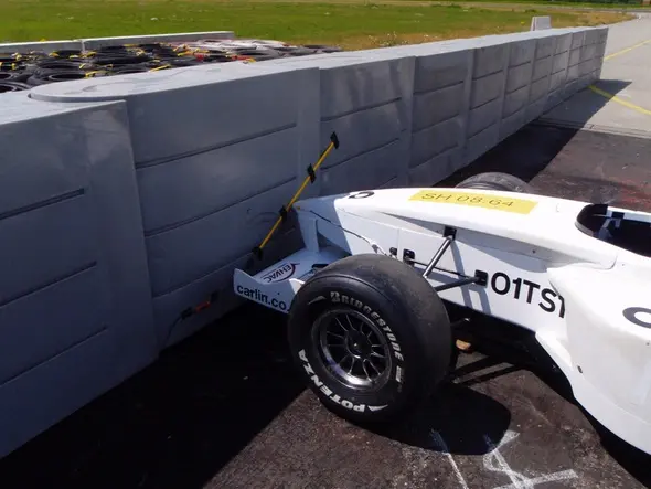 Racing car crashes into barrier