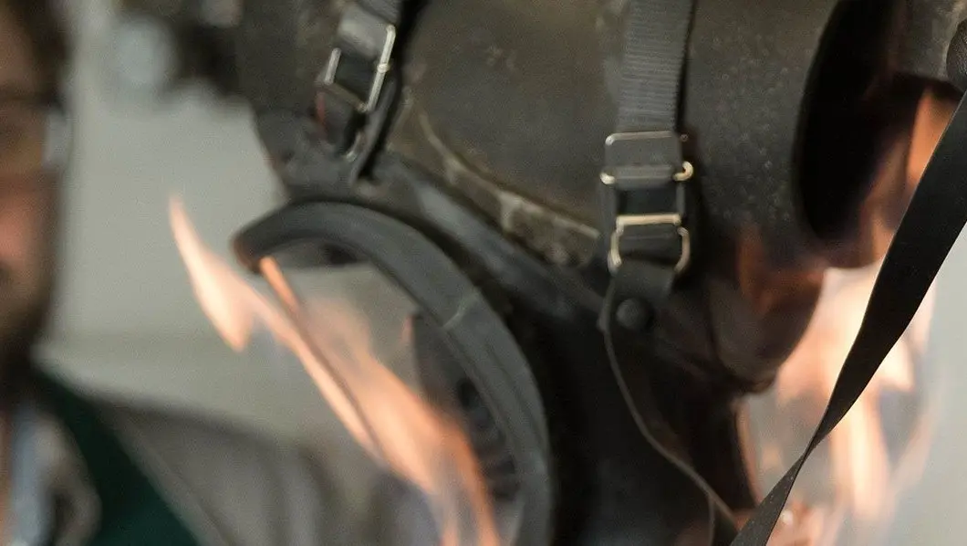 Protective mask in flames during heat resistance testing