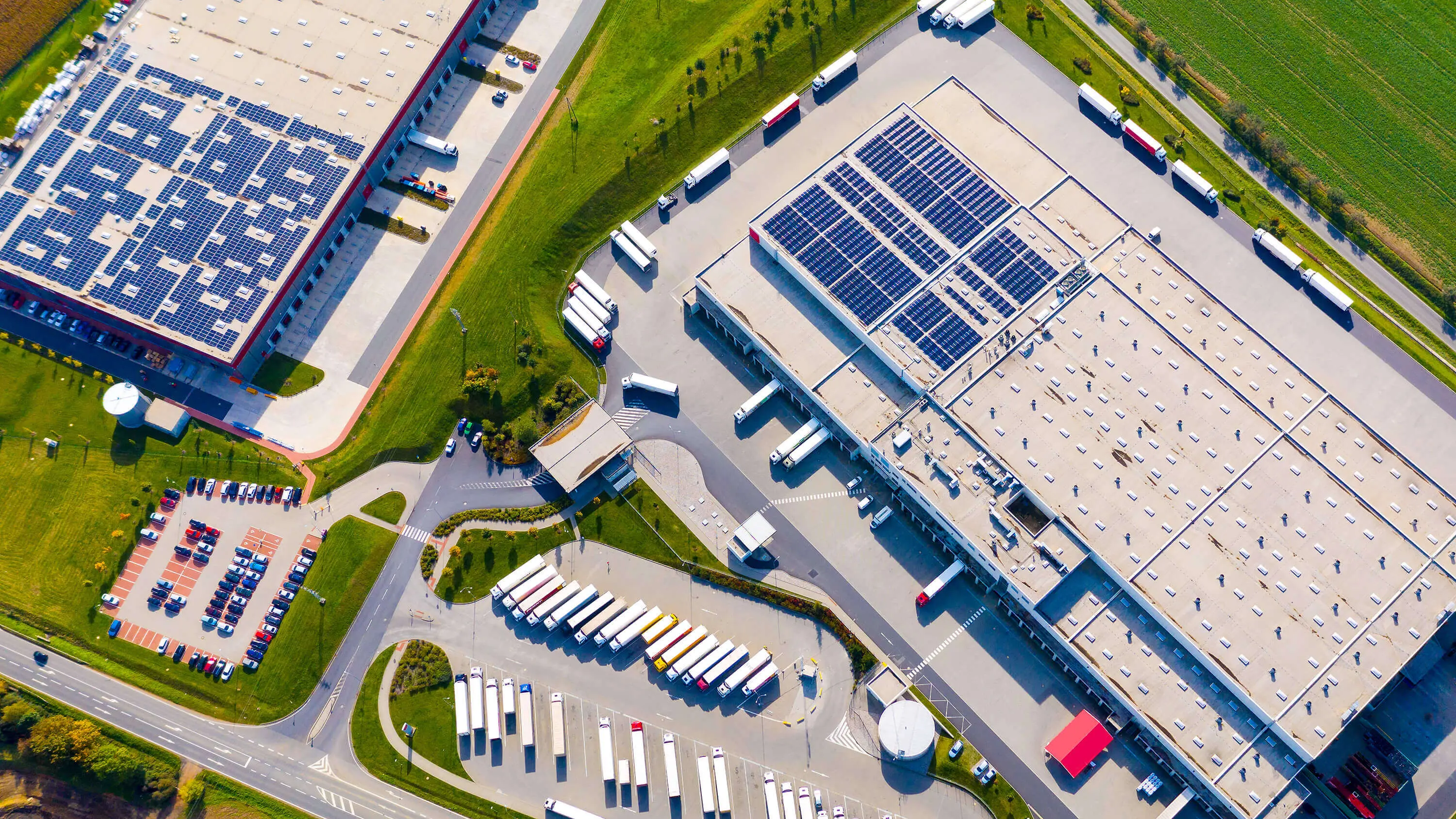 Aerial view of an industrial facility with buildings, storage areas, and infrastructure