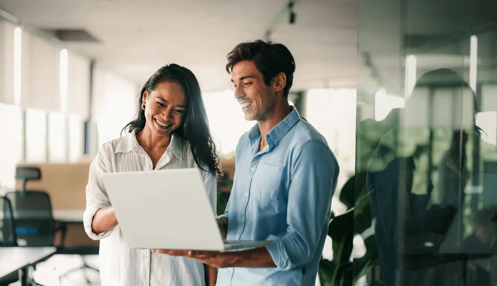 two people looking onto a laptop