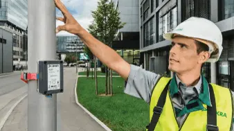 DEKRA inspector testing the stability of the poles