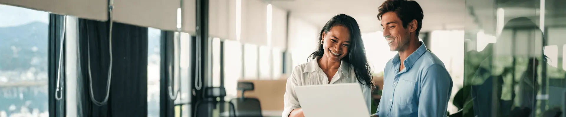 two person looking at laptop