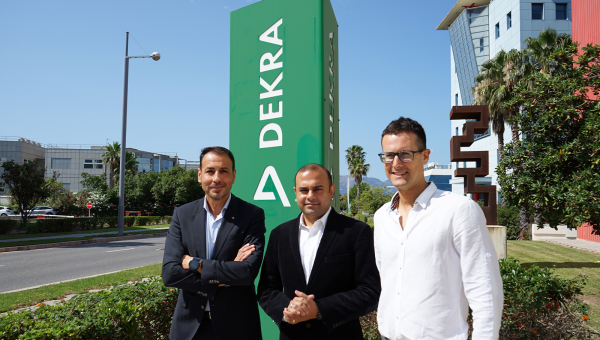 Men standing in front of dekra sign Men standing in front of dekra sign