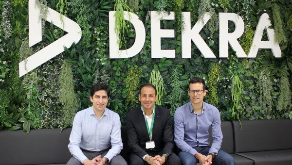 Men sitting in front of DEKRA wall Men sitting in front of DEKRA wall