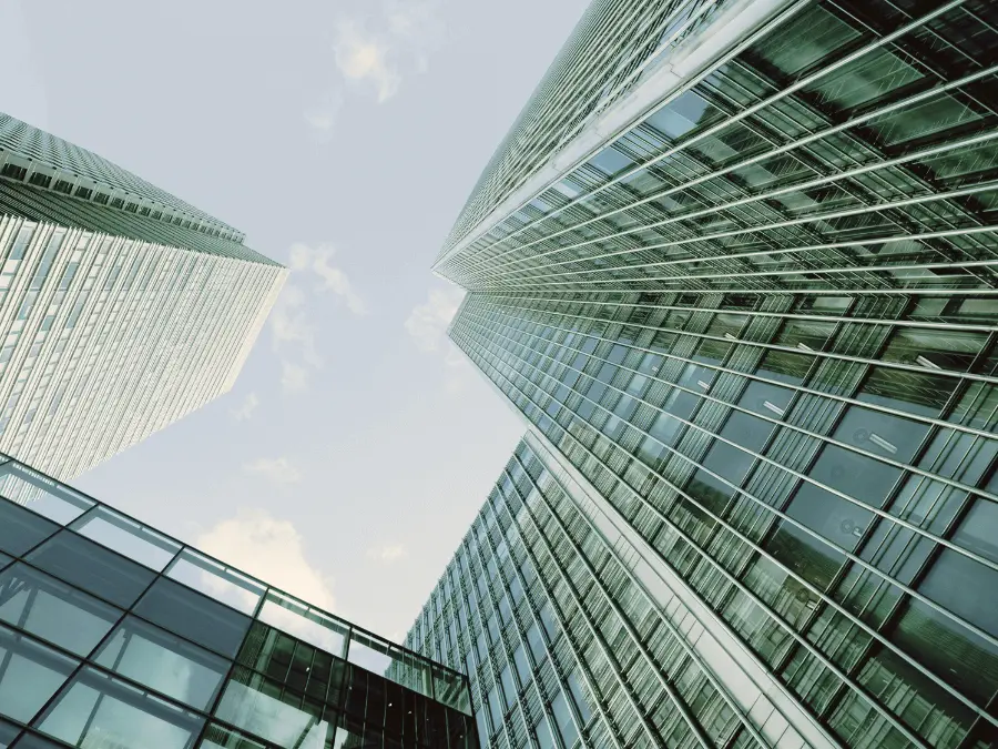 View of modern office buildings from below, looking upward toward the sky