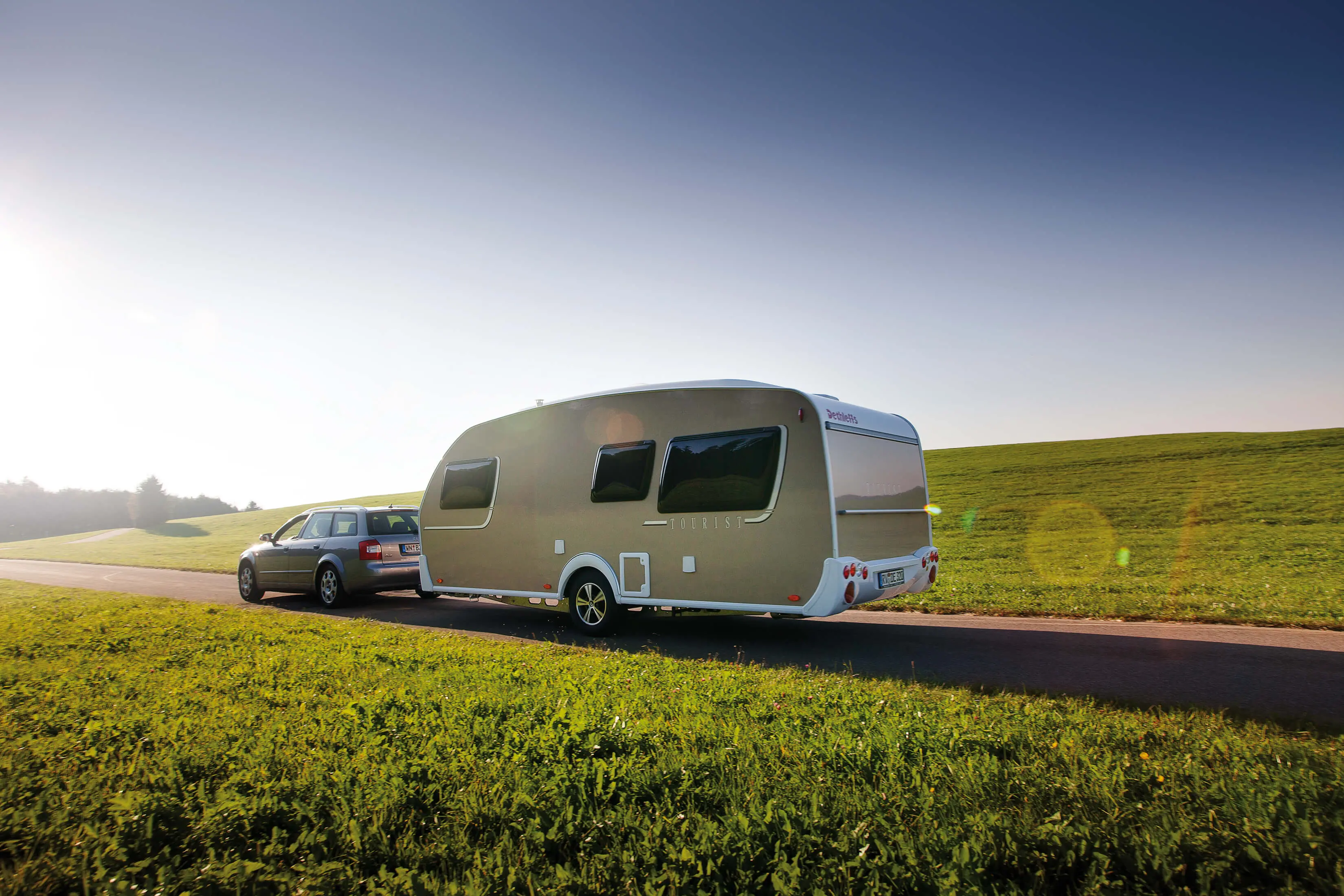 car with caravan driving on the road
