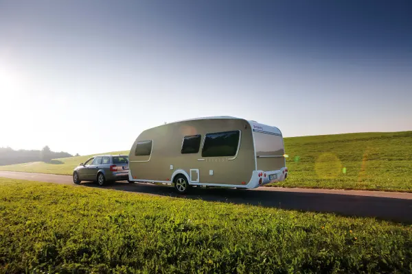 car with caravan driving on the road car with caravan driving on the road