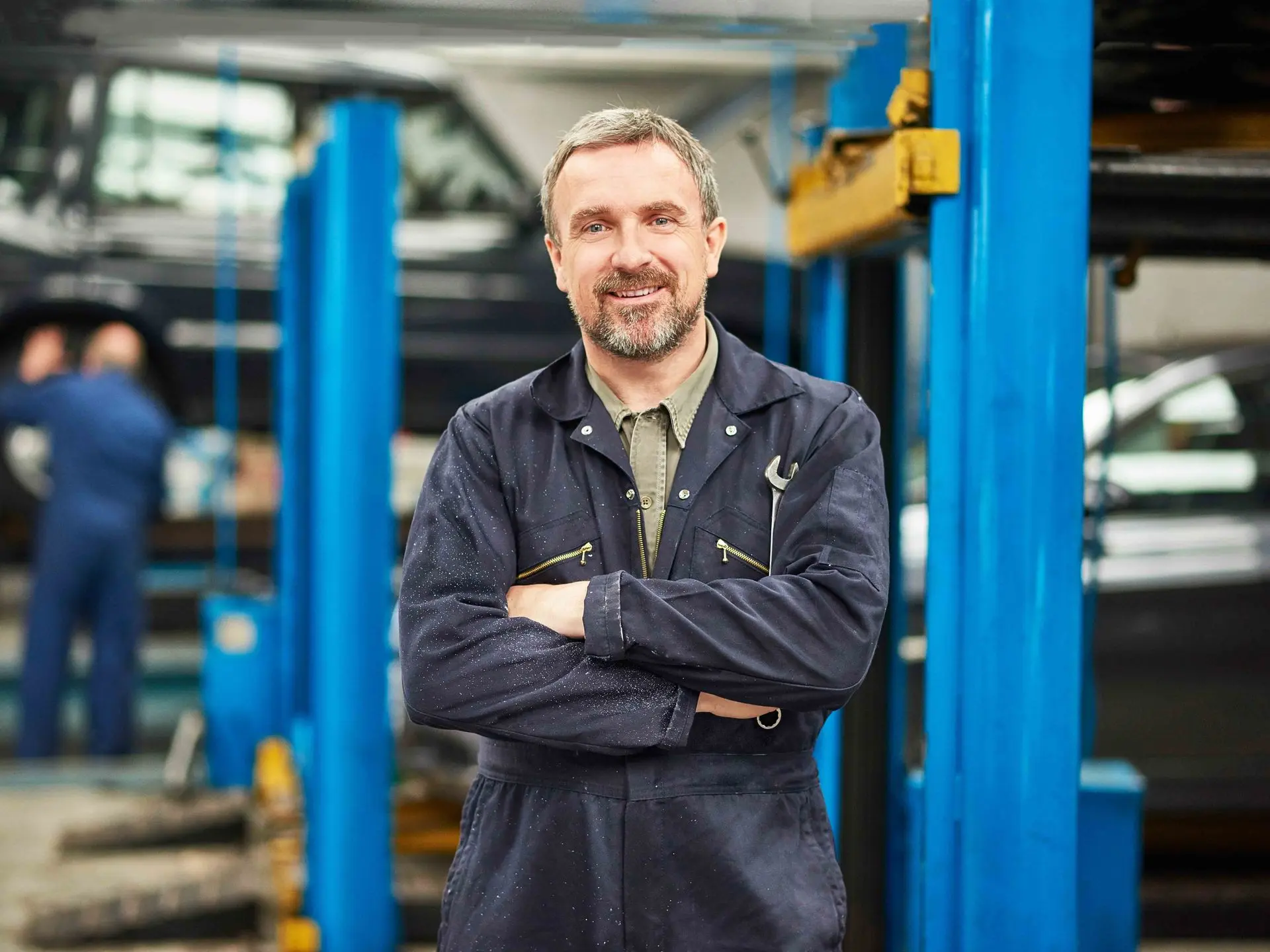 Blue-collar worker with a mechanic's workshop in the background