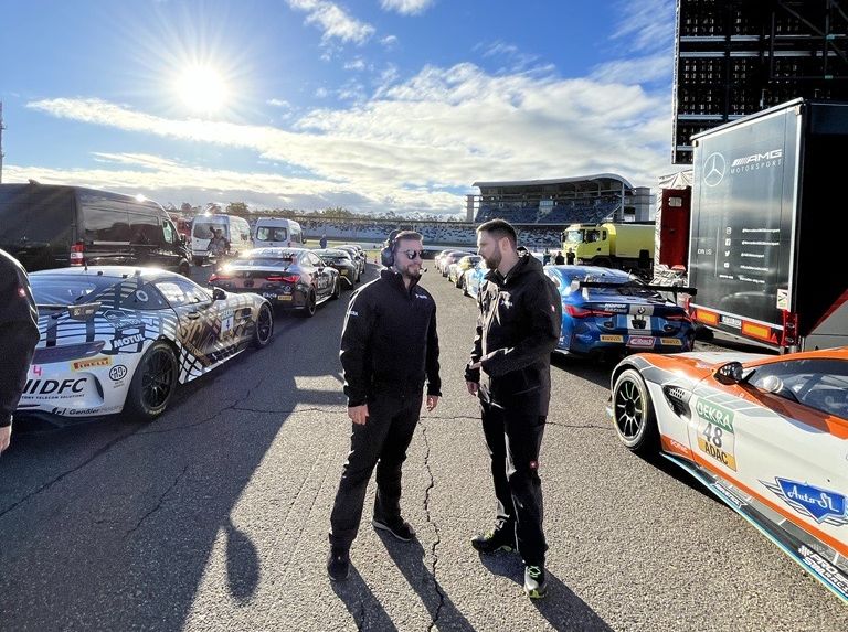 Two DEKRA inspectors next to the race track