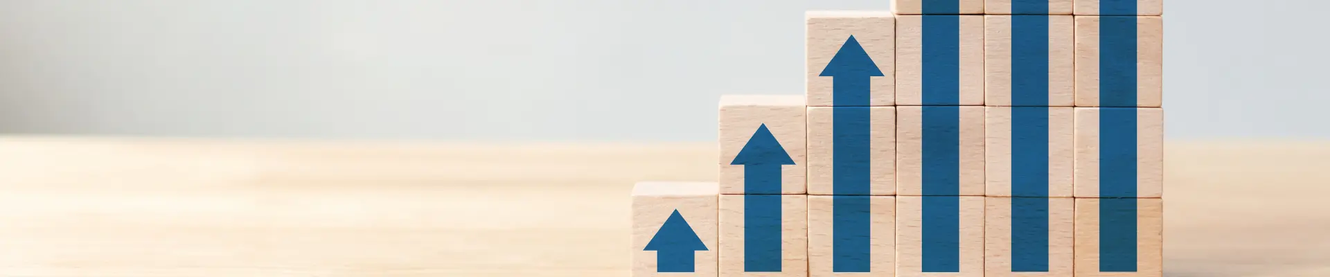 Wooden rectangular blocks with blue arrows pointing upward.