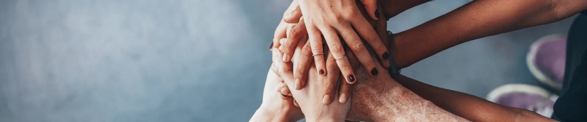 several hands joined together in the center