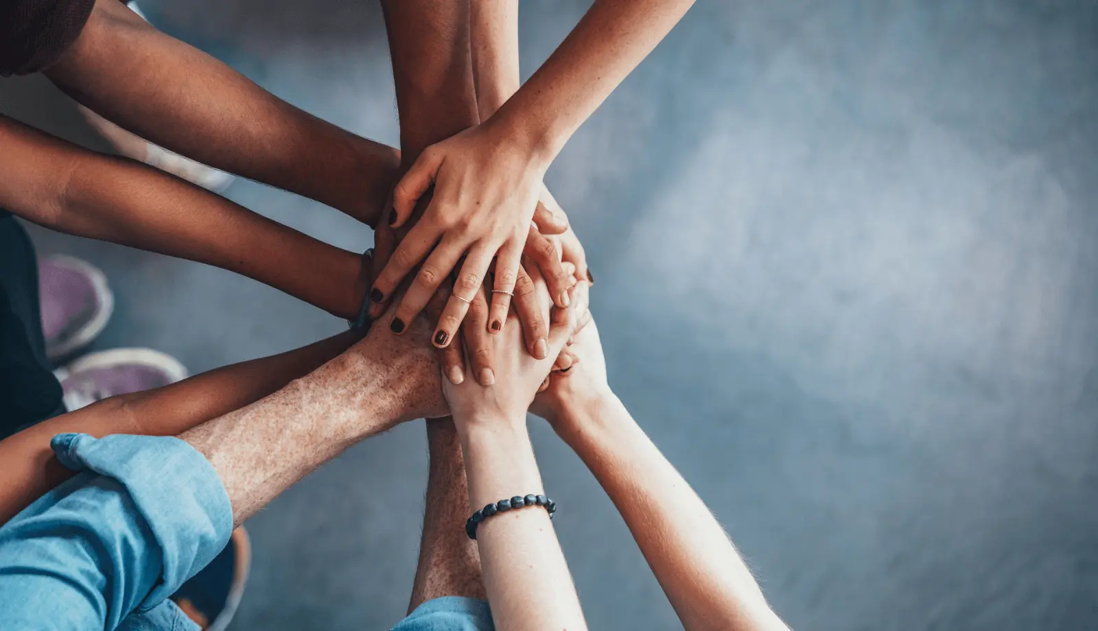several hands joined together in the center