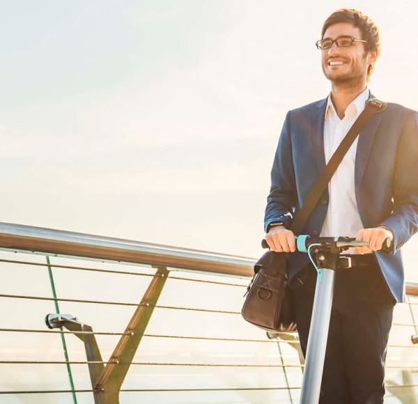 Man in a suit on an E-scooter