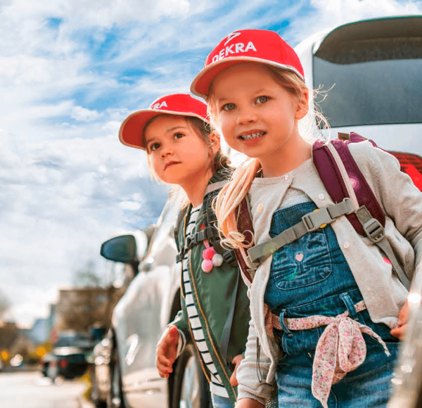 Children crossing the road between cars