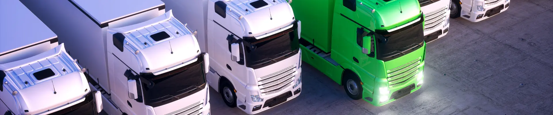 Several trucks lined up next to each other, with one green truck standing out among otherwise white trucks