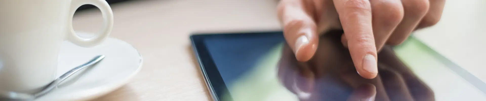 Hand interacting with a tablet touchscreen