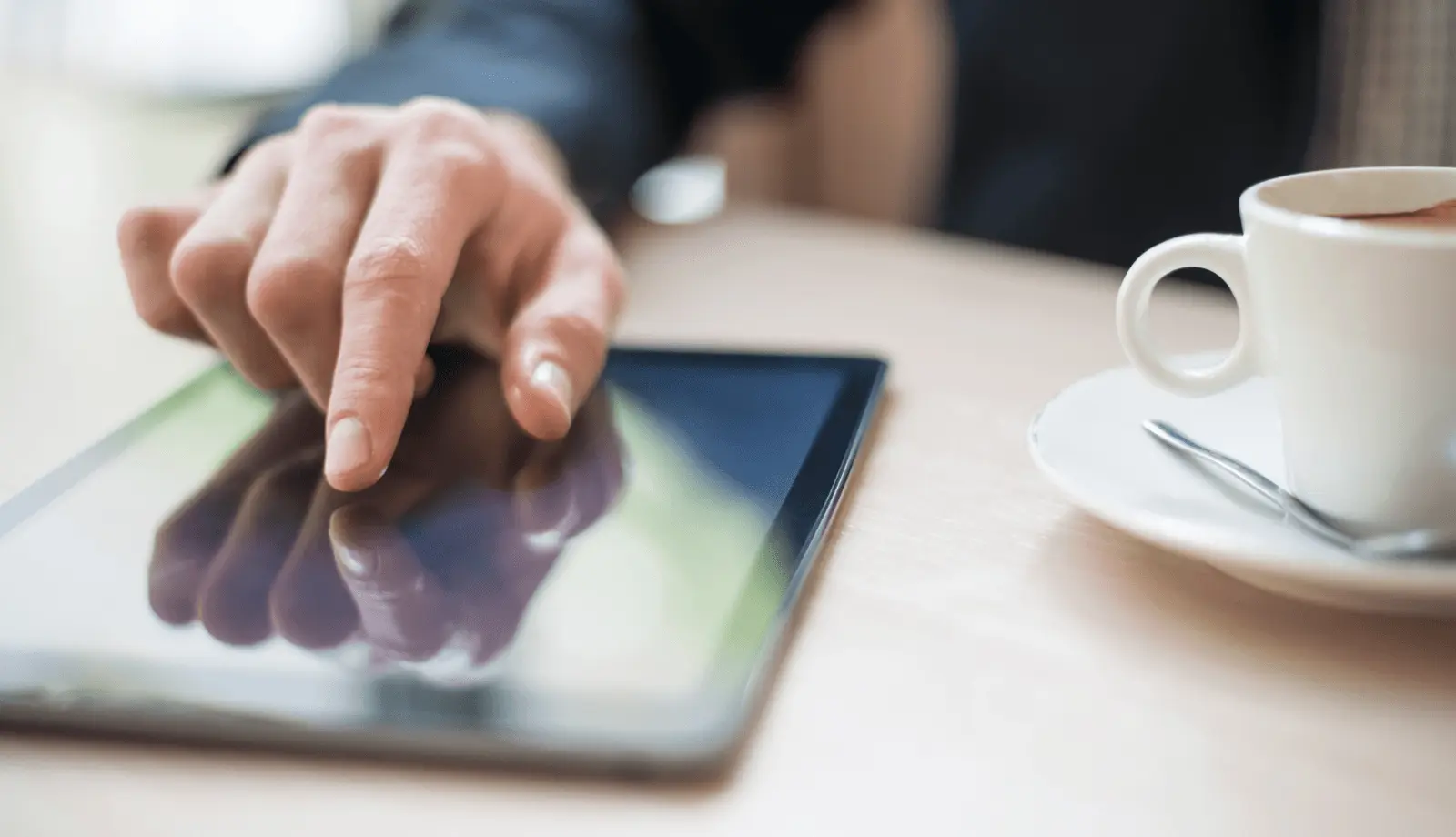 Hand interacting with a tablet touchscreen