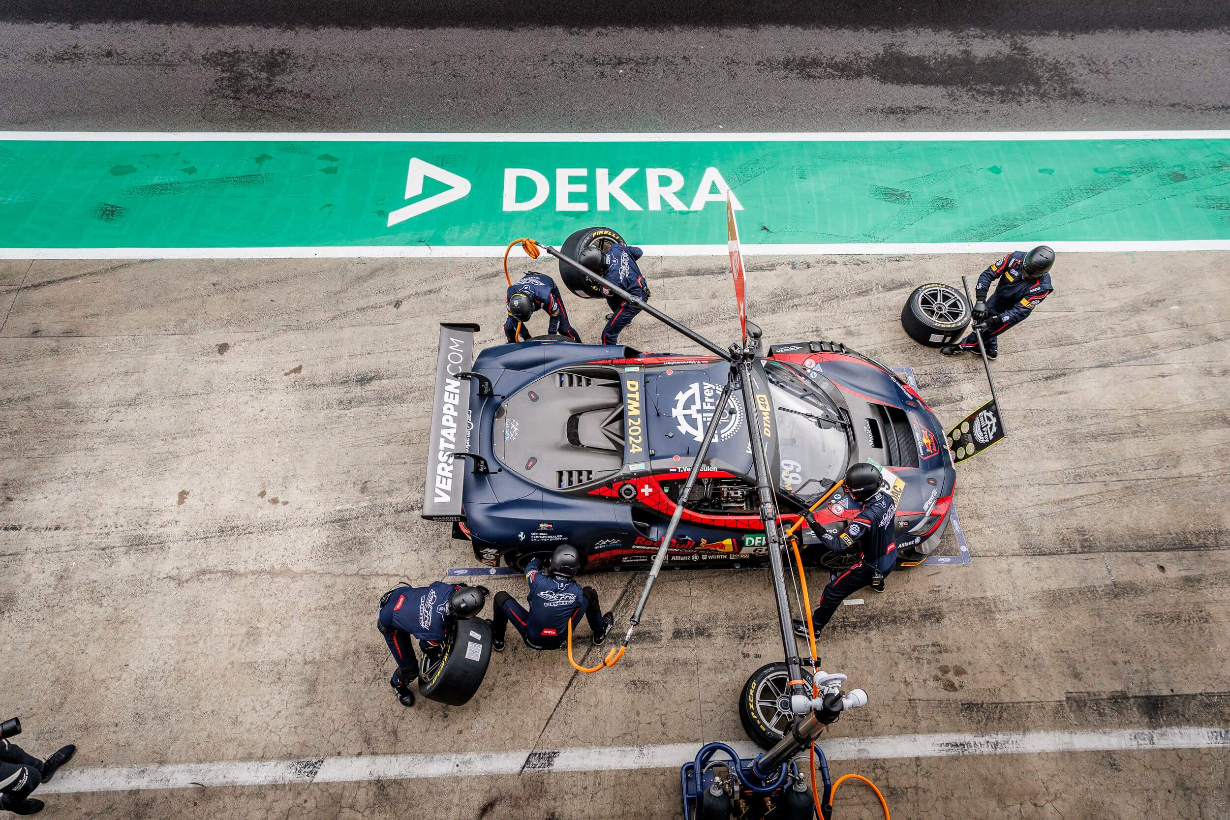 DTM race car at pit stop with DEKRA asphalt