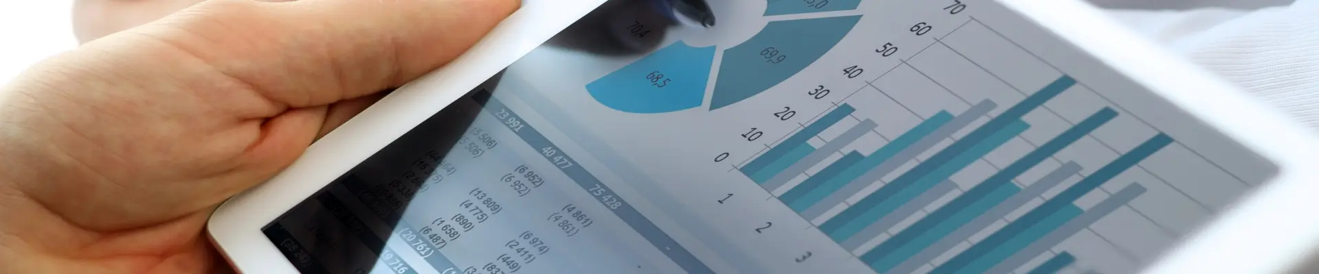 A tablet showing a dashboard with charts and business performance metrics.
