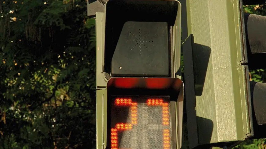 Pedestrian light with amber light informing pedestrians how much time they have left to cross the road
