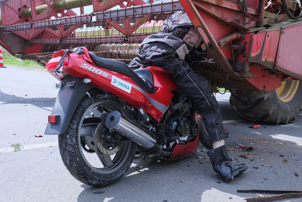 Una motocicleta choca contra una cosechadora.