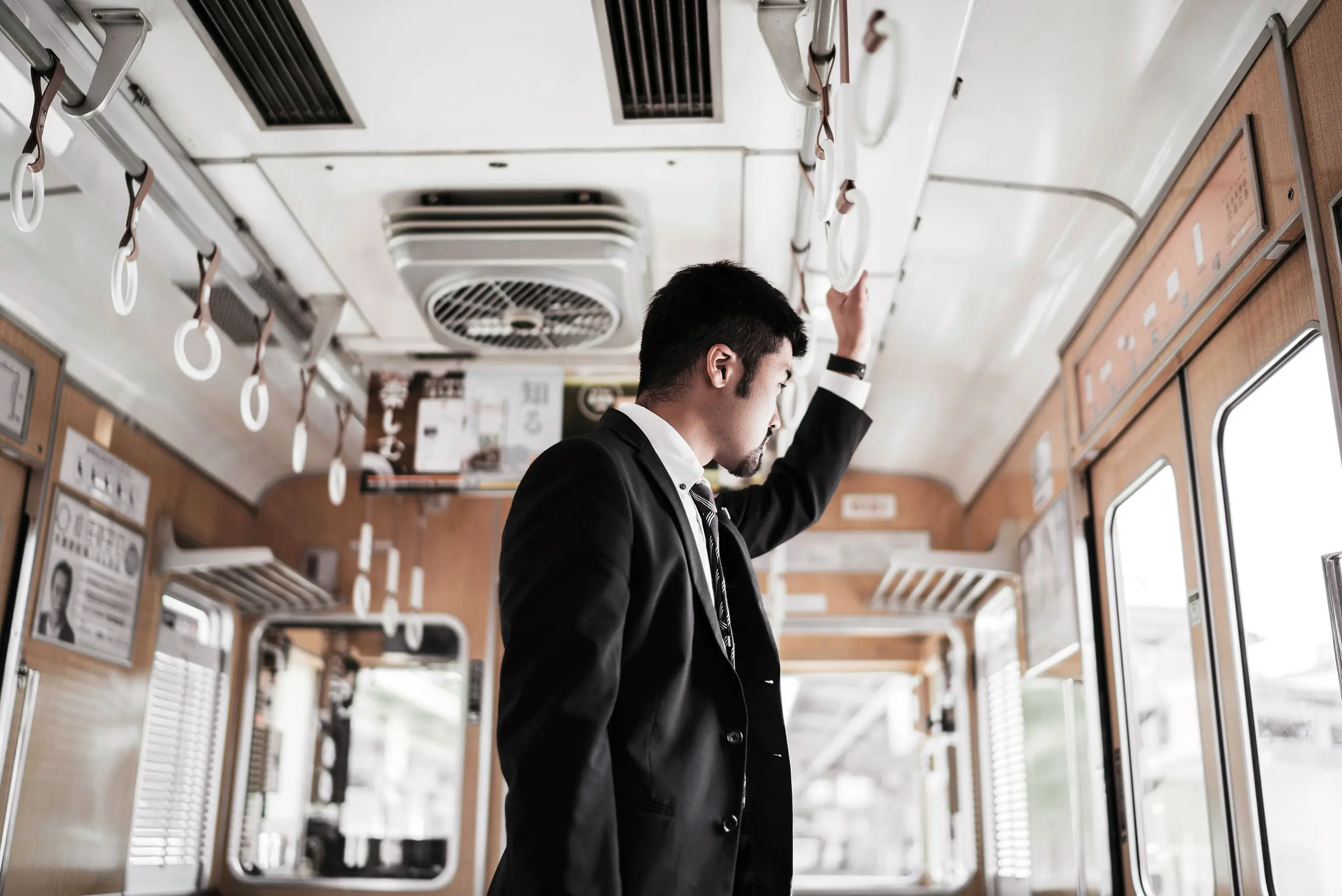 A man looking out of a bus window 