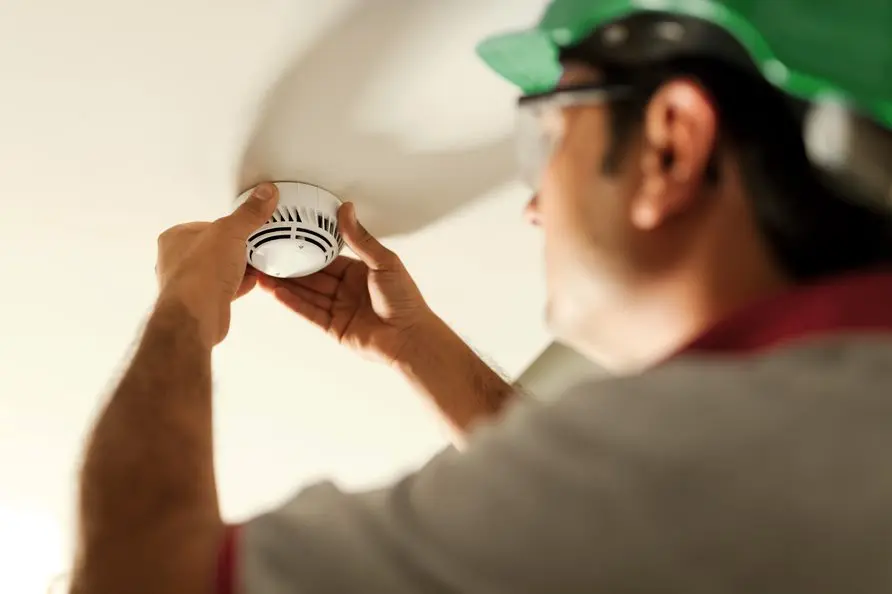 An expert checks a fire alarm system 