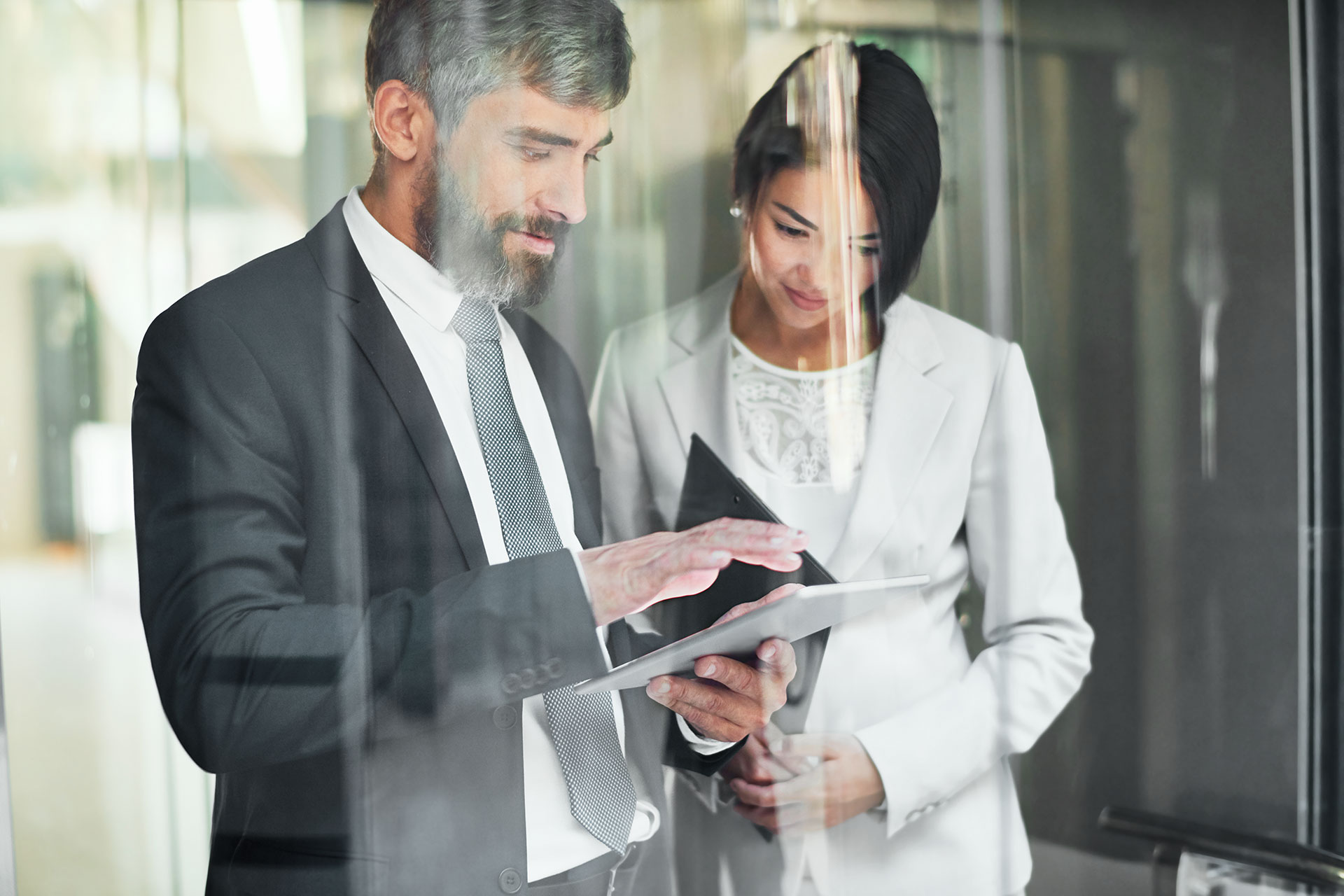 Two person looking at a tablet