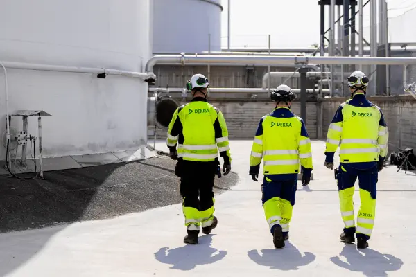 Three DEKRA inspectors walking around the factory site