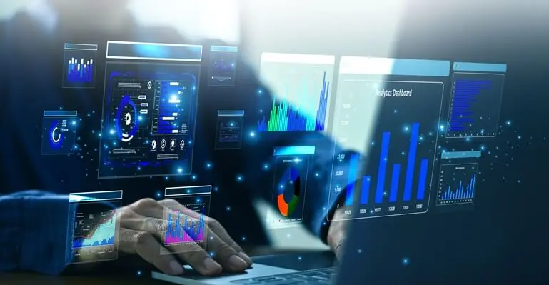 A man sitting in front of a computer screen displaying analysis calculations in various colors. A man sitting in front of a computer screen displaying analysis calculations in various colors.