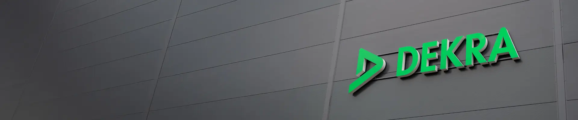 A man in a white hard hat and reflective work clothes, prepared for safety, exemplifying professionalism in a construction environment. 