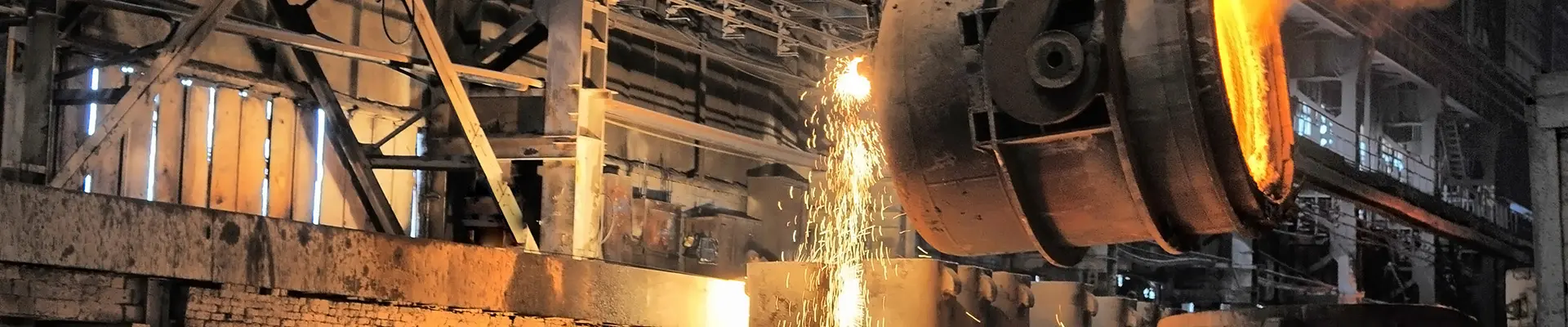 A large steel mill featuring a prominent beam of metal, showcasing industrial machinery and production processes.