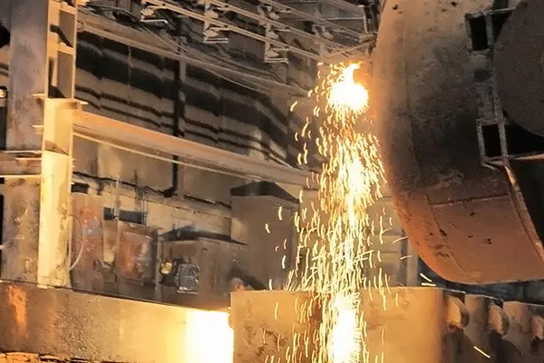 A large steel mill featuring a prominent beam of metal, showcasing industrial machinery and production processes.