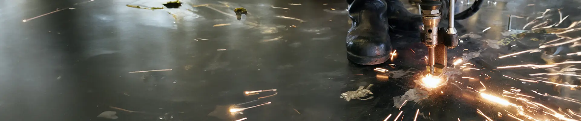 Welders stand on the floor and resistance weld against the floor.
