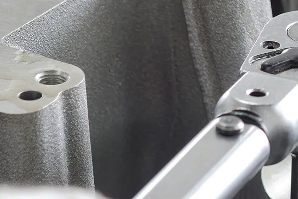 A close-up view of a metallic tool, a Calibrating Torque Wrench, highlighting intricate details and textures.