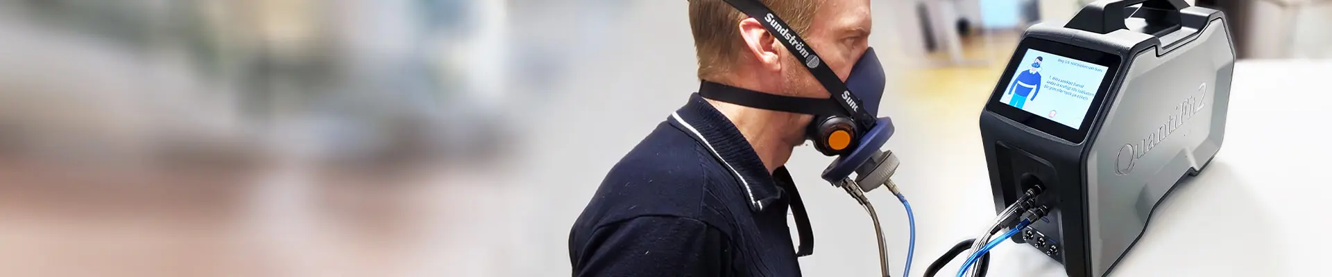A man and a woman are watching a screen together.