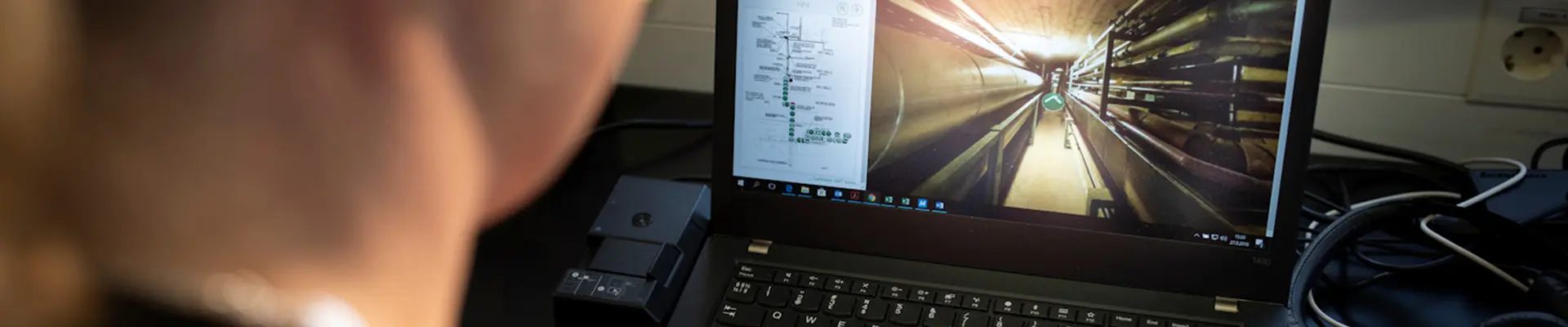 A woman from behind sitting and looking at a computer screen. A woman from behind sitting and looking at a computer screen.