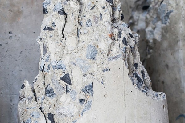 Broken narrow concrete pillars lying on the ground.