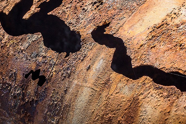 A close-up view of a rusty piece of metal, showcasing its textured surface and weathered appearance.