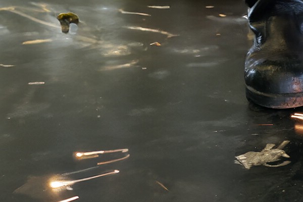 Welders stand on the floor and resistance weld against the floor.