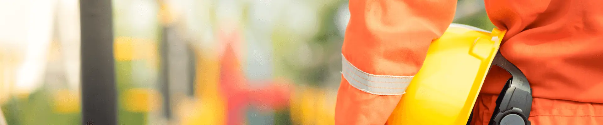 Man in orange uniform holding hard hat Man in orange uniform holding hard hat